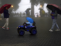 Pedestrians are carrying umbrellas during heavy rainfall in Darjeeling, India, on July 1, 2024. Darjeeling is a famous tourist destination i...