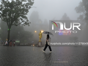 A pedestrian is carrying an umbrella during heavy rainfall in Darjeeling, India, on July 1, 2024. Darjeeling is a famous tourist destination...