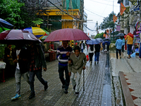 Pedestrians are carrying umbrellas during heavy rainfall in Darjeeling, India, on July 1, 2024. Darjeeling is a famous tourist destination i...