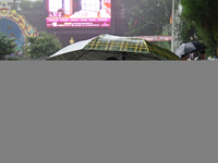 Pedestrians are carrying umbrellas during heavy rainfall in Darjeeling, India, on July 1, 2024. Darjeeling is a famous tourist destination i...