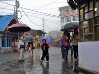 Pedestrians are carrying umbrellas during heavy rainfall in Darjeeling, India, on July 1, 2024. Darjeeling is a famous tourist destination i...