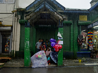 A toy seller is taking shelter during heavy rainfall in Darjeeling, India, on July 1, 2024. Darjeeling is a famous tourist destination in No...