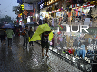 Pedestrians are carrying umbrellas during heavy rainfall in Darjeeling, India, on July 1, 2024. Darjeeling is a famous tourist destination i...