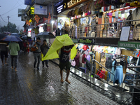 Pedestrians are carrying umbrellas during heavy rainfall in Darjeeling, India, on July 1, 2024. Darjeeling is a famous tourist destination i...