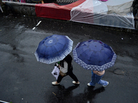 Pedestrians are carrying umbrellas during heavy rainfall in Darjeeling, India, on July 1, 2024. Darjeeling is a famous tourist destination i...