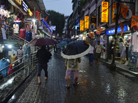 Pedestrians are carrying umbrellas during heavy rainfall in Darjeeling, India, on July 1, 2024. Darjeeling is a famous tourist destination i...