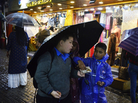 School children are carrying umbrellas during heavy rainfall in Darjeeling, India, on July 1, 2024. Darjeeling is a famous tourist destinati...