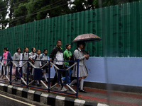 School students are carrying umbrellas during heavy rainfall in Darjeeling, India, on July 1, 2024. Darjeeling is a famous tourist destinati...