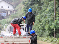 Power emergency repair workers are unloading emergency supplies in the rain at Si 'an village in Liuzhou city, Guangxi Province, China, on J...