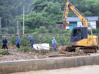 An electric worker is carrying out a repair operation at Si'an Village in Liuzhou, China, on July 2, 2024. (