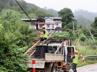 An electric worker is carrying out a repair operation at Si'an Village in Liuzhou, China, on July 2, 2024. (