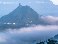 The fields, houses, mountains, and villages of Zhimu Village are appearing in the morning fog after returning farmland to forest in Chongqin...