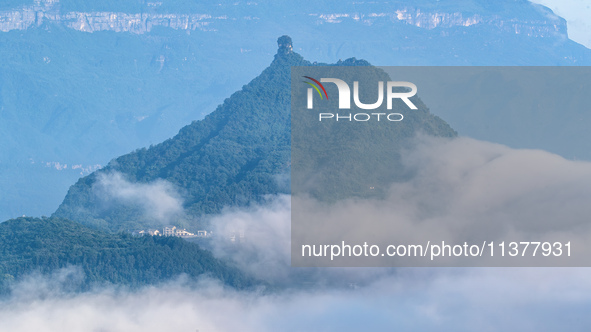 The fields, houses, mountains, and villages of Zhimu Village are appearing in the morning fog after returning farmland to forest in Chongqin...