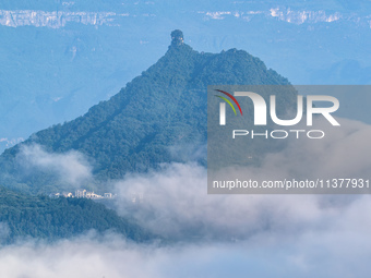 The fields, houses, mountains, and villages of Zhimu Village are appearing in the morning fog after returning farmland to forest in Chongqin...