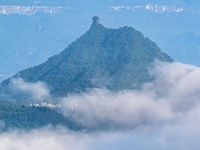 The fields, houses, mountains, and villages of Zhimu Village are appearing in the morning fog after returning farmland to forest in Chongqin...