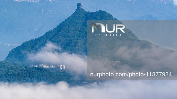 The fields, houses, mountains, and villages of Zhimu Village are appearing in the morning fog after returning farmland to forest in Chongqin...