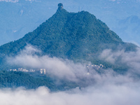 The fields, houses, mountains, and villages of Zhimu Village are appearing in the morning fog after returning farmland to forest in Chongqin...