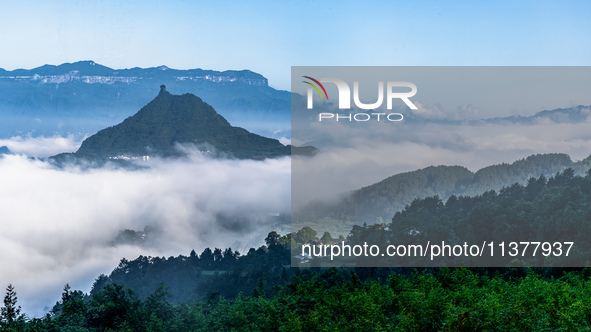 The fields, houses, mountains, and villages of Zhimu Village are appearing in the morning fog after returning farmland to forest in Chongqin...