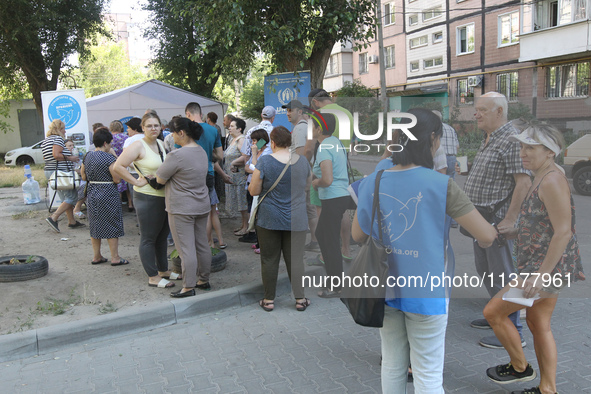 Locals affected by a recent Russian missile attack are queuing to get help in Dnipro, Ukraine, on July 1, 2024. Russia is launching a missil...