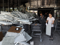 People are removing the debris from a supermarket damaged by a recent Russian missile attack in Dnipro, Ukraine, on July 1, 2024. Russia is...