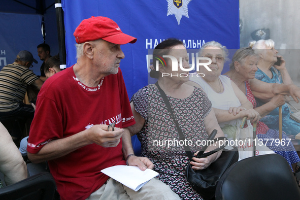 Elderly people are gathering at a coordination headquarters set up to help people affected by a recent Russian missile attack in Dnipro, Ukr...