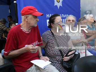 Elderly people are gathering at a coordination headquarters set up to help people affected by a recent Russian missile attack in Dnipro, Ukr...