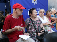 Elderly people are gathering at a coordination headquarters set up to help people affected by a recent Russian missile attack in Dnipro, Ukr...