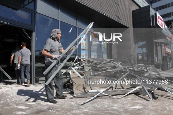 People are removing the debris from a supermarket damaged by a recent Russian missile attack in Dnipro, Ukraine, on July 1, 2024. Russia is...