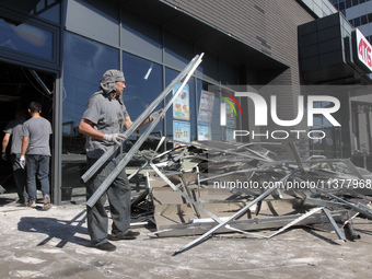 People are removing the debris from a supermarket damaged by a recent Russian missile attack in Dnipro, Ukraine, on July 1, 2024. Russia is...