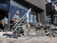 People are removing the debris from a supermarket damaged by a recent Russian missile attack in Dnipro, Ukraine, on July 1, 2024. Russia is...