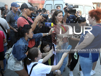 A woman affected by a recent Russian missile attack at a coordination headquarters is speaking to the press in Dnipro, Ukraine, on July 1, 2...