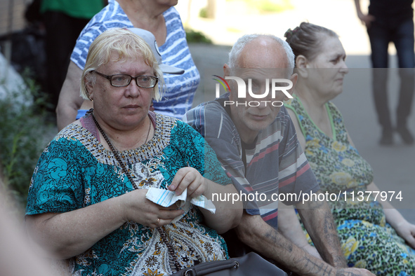 Elderly people are gathering at a coordination headquarters set up to help people affected by a recent Russian missile attack in Dnipro, Ukr...