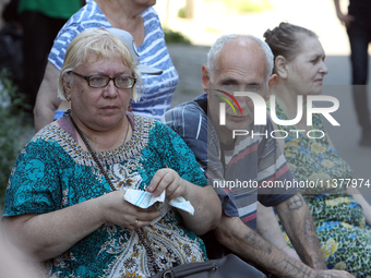 Elderly people are gathering at a coordination headquarters set up to help people affected by a recent Russian missile attack in Dnipro, Ukr...