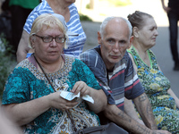 Elderly people are gathering at a coordination headquarters set up to help people affected by a recent Russian missile attack in Dnipro, Ukr...