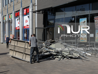 Men are carrying damaged items out of a supermarket affected by a recent Russian missile attack in Dnipro, Ukraine, on July 1, 2024. Russia...