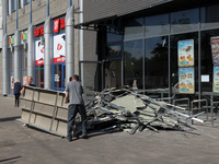 Men are carrying damaged items out of a supermarket affected by a recent Russian missile attack in Dnipro, Ukraine, on July 1, 2024. Russia...