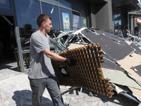 A man is carrying a damaged item out of a supermarket affected by a recent Russian missile attack in Dnipro, Ukraine, on July 1, 2024. Russi...