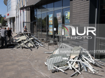 Men are carrying damaged items out of a supermarket affected by a recent Russian missile attack in Dnipro, Ukraine, on July 1, 2024. Russia...