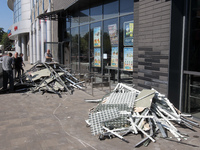 Men are carrying damaged items out of a supermarket affected by a recent Russian missile attack in Dnipro, Ukraine, on July 1, 2024. Russia...