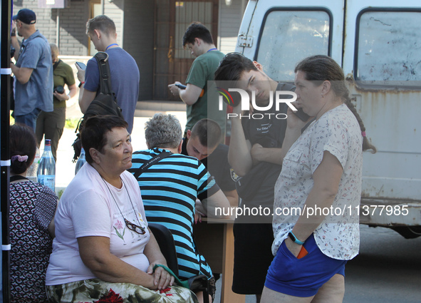 Locals are gathering at a coordination headquarters set up to help people affected by a recent Russian missile attack in Dnipro, Ukraine, on...