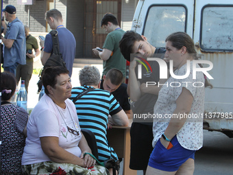 Locals are gathering at a coordination headquarters set up to help people affected by a recent Russian missile attack in Dnipro, Ukraine, on...