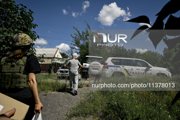 Volodymyr is walking towards a police car during the evacuation from the rural settlement of Stepnohirsk, which is shelled daily by Russian...