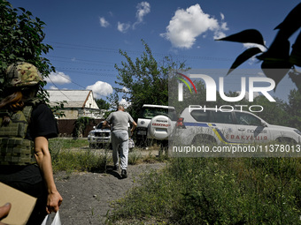 Volodymyr is walking towards a police car during the evacuation from the rural settlement of Stepnohirsk, which is shelled daily by Russian...