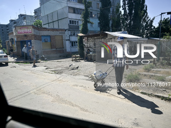 Locals are being pictured in the street in the rural settlement of Stepnohirsk that is being shelled daily by Russian troops as the team of...