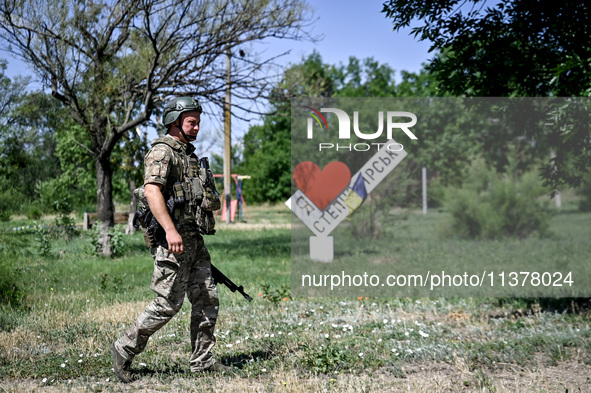 A community police officer is being seen in the street in the rural settlement of Stepnohirsk, Ukraine, on June 28, 2024, which is being she...