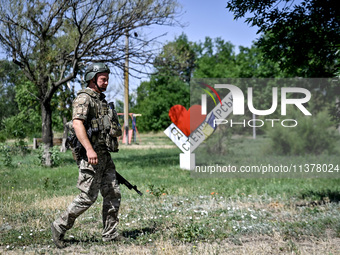 A community police officer is being seen in the street in the rural settlement of Stepnohirsk, Ukraine, on June 28, 2024, which is being she...