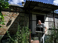 Volodymyr is carrying a microwave oven during the evacuation from the rural settlement of Stepnohirsk, which is being shelled daily by Russi...