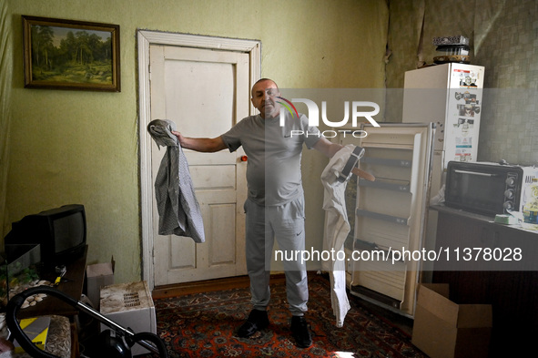 Volodymyr is standing in the room during the evacuation from the rural settlement of Stepnohirsk that is being shelled daily by Russian troo...