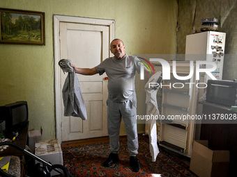 Volodymyr is standing in the room during the evacuation from the rural settlement of Stepnohirsk that is being shelled daily by Russian troo...