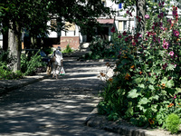 An elderly woman is carrying bags towards an apartment block in the rural settlement of Stepnohirsk, Ukraine, on June 28, 2024, which is bei...